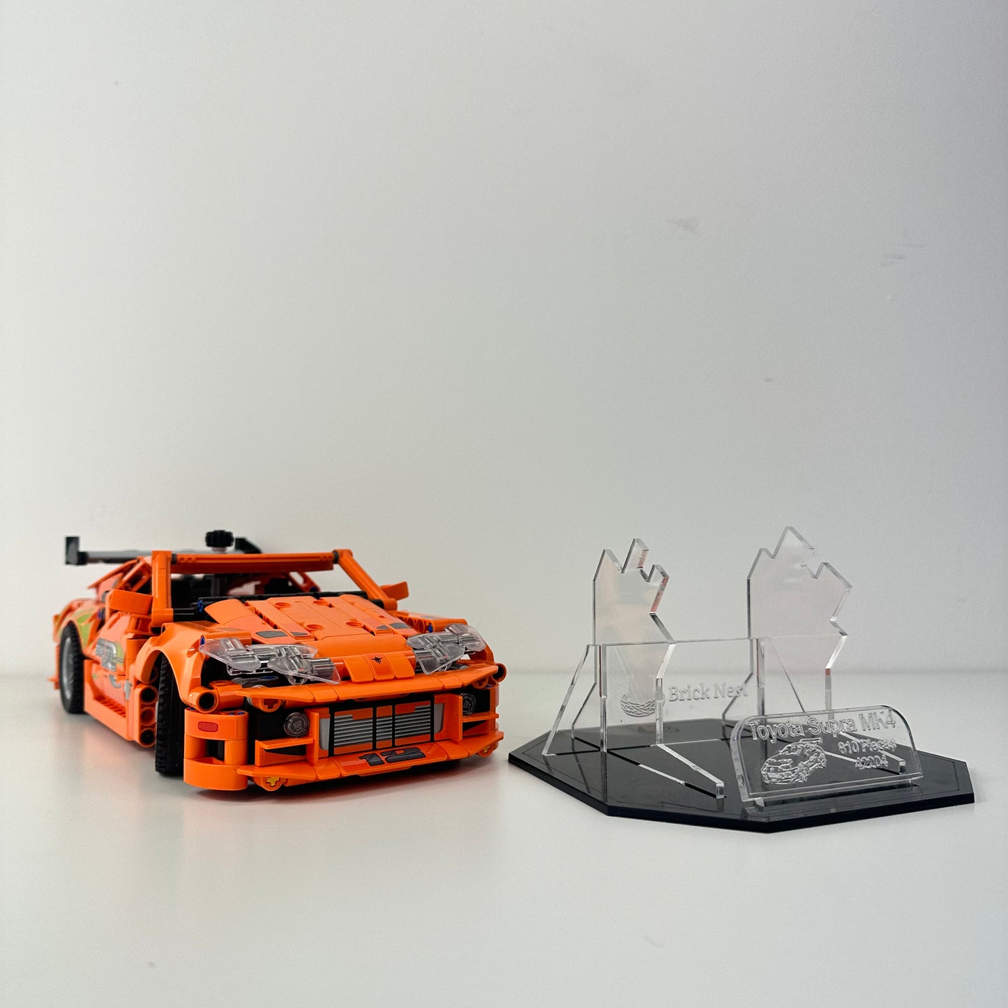 Lego Toyota Supra MK4 model with black acrylic base for display