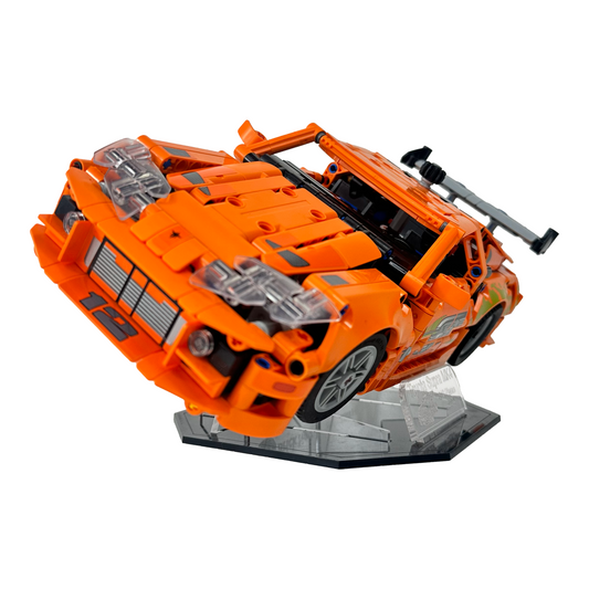 Angled view of Lego Toyota Supra MK4 model displayed on premium black base