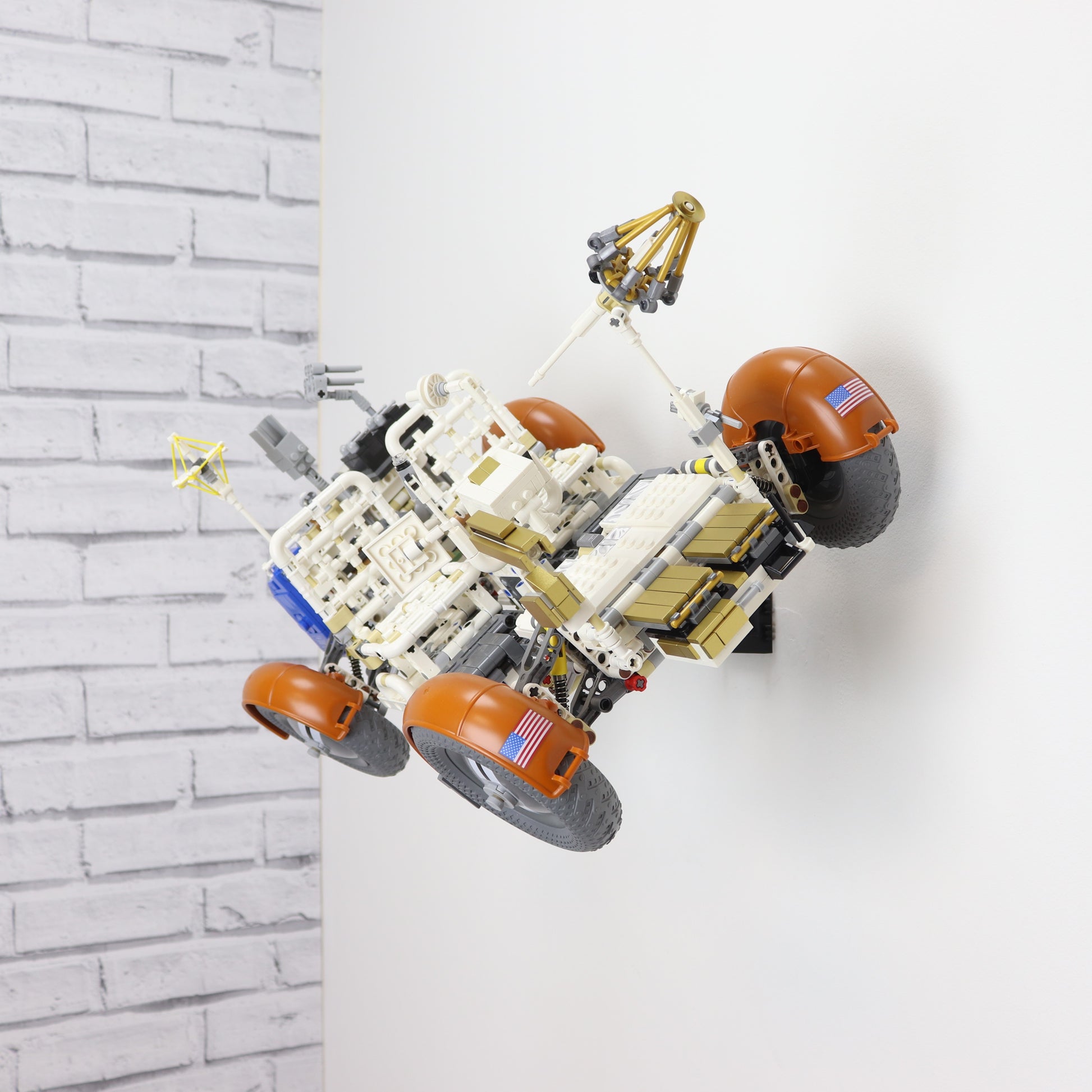 Wall display mount holding LEGO® Lunar Roving Vehicle (LRV 42182) model, showcasing the vehicle at an angled position on the wall for an eye-catching display.
