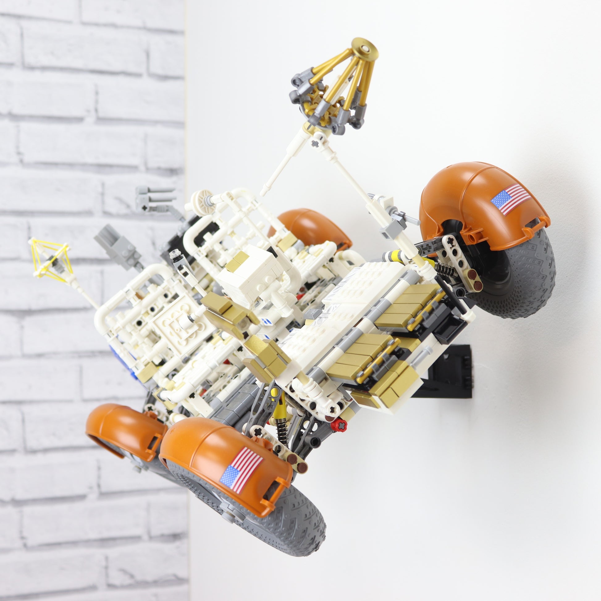 Wall display mount holding LEGO® Lunar Roving Vehicle (LRV 42182) model, showcasing the vehicle at an angled position on the wall for an eye-catching display.
